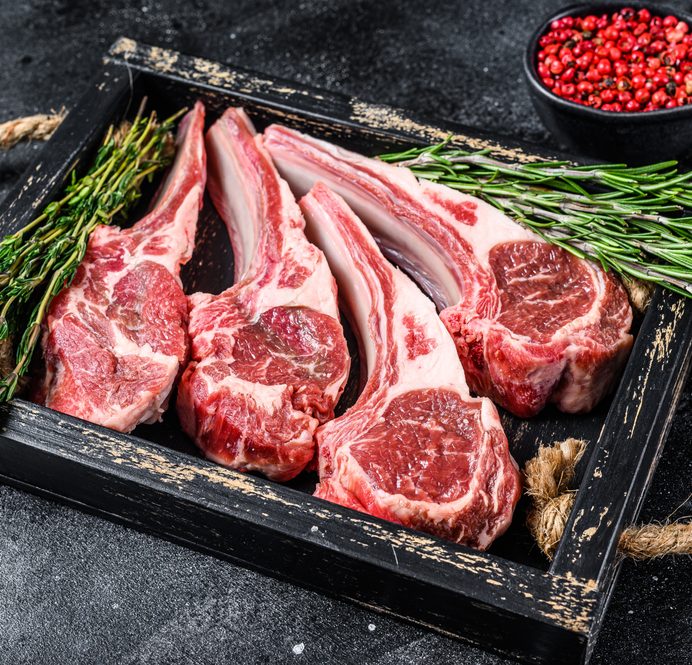 Raw,Lamb,Meat,Chops,Steaks,In,A,Wooden,Tray.,Black